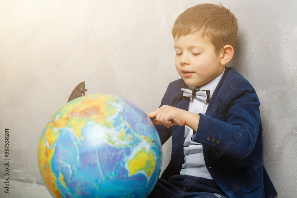 Happy curious kid little boy genius on gray background Happy curious kid little boy genius on gray background