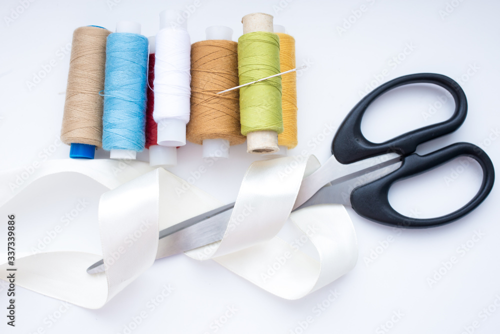 Accessories for needlework thread, tape, scissors on a white background, Accessories for needlework thread, tape, scissors on a white background,