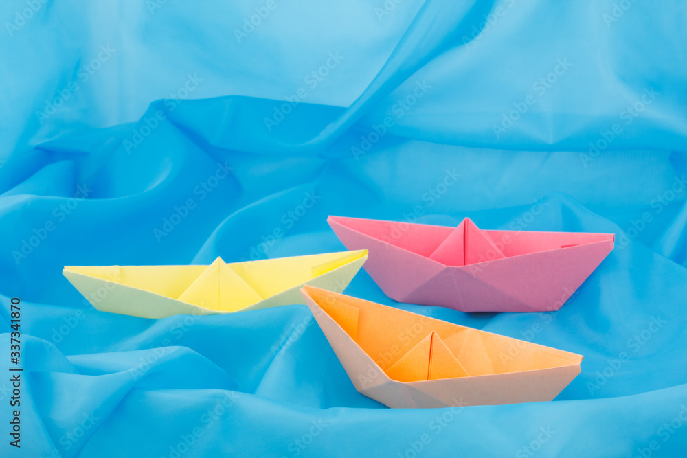 paper boats on a blue background paper boats on a blue background