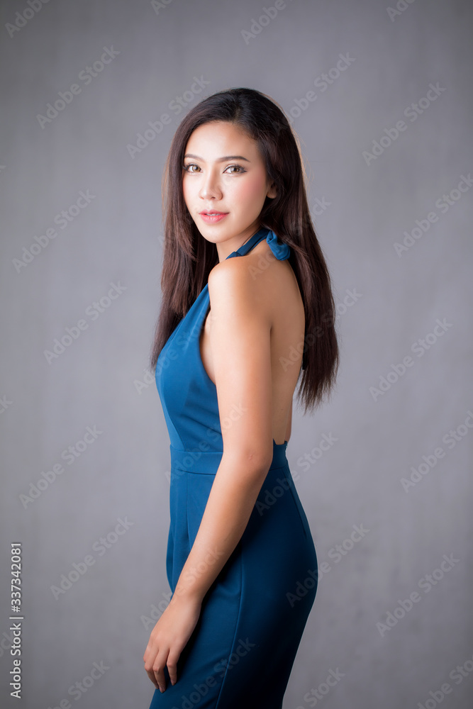 Beautiful Asian woman wear blue dress pants. Standing in front of a white background. Beautiful Asian woman wear blue dress pants. Standing in front of a white background.