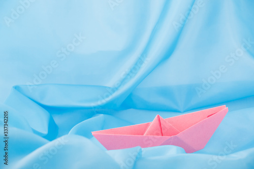 paper boat on a blue background