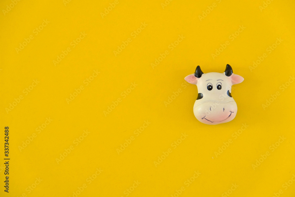Cow icon on yellow background. Minimal concept. Top view. Copy, empty space for text Cow icon on yellow background. Minimal concept. Top view. Copy, empty space for text