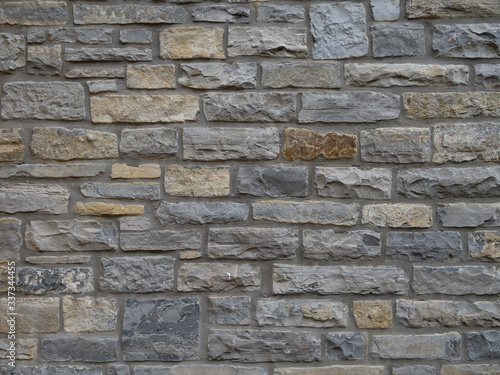 Tableau sur toile Traditional local stone house wall in Street, Somerset, England