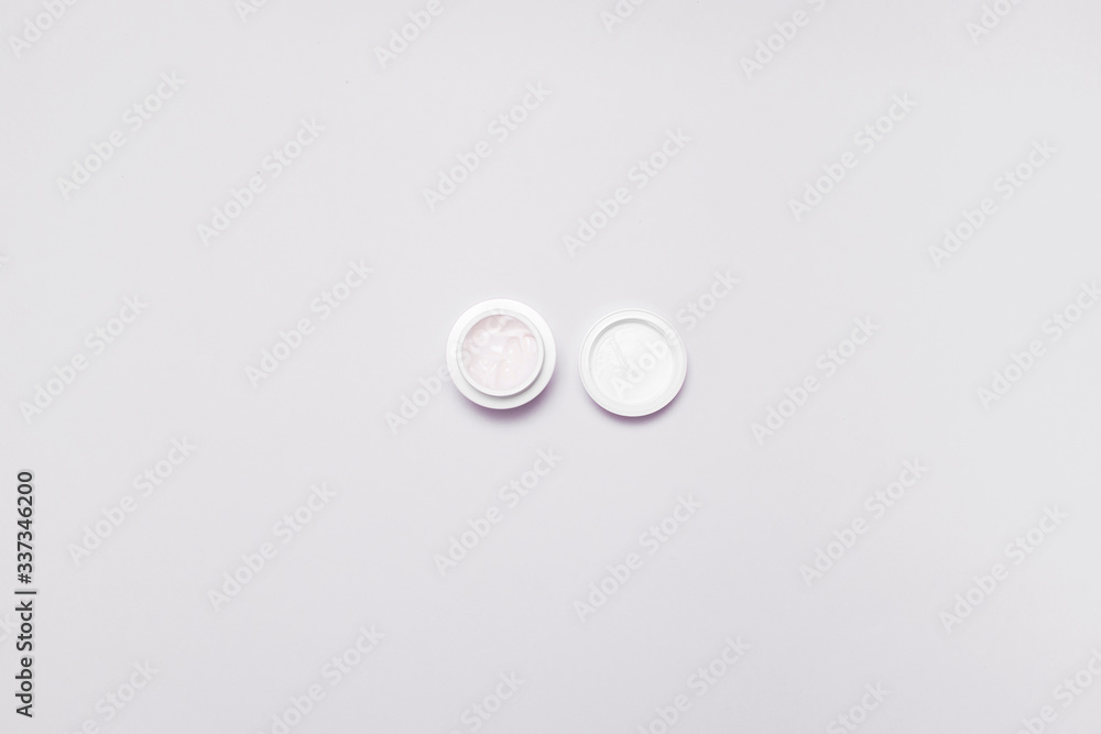 Moisturizer cream jar on grey white background. Flat lay, top view, copy space. Natural organic product Moisturizer cream jar on grey white background. Flat lay, top view, copy space. Natural organic product
