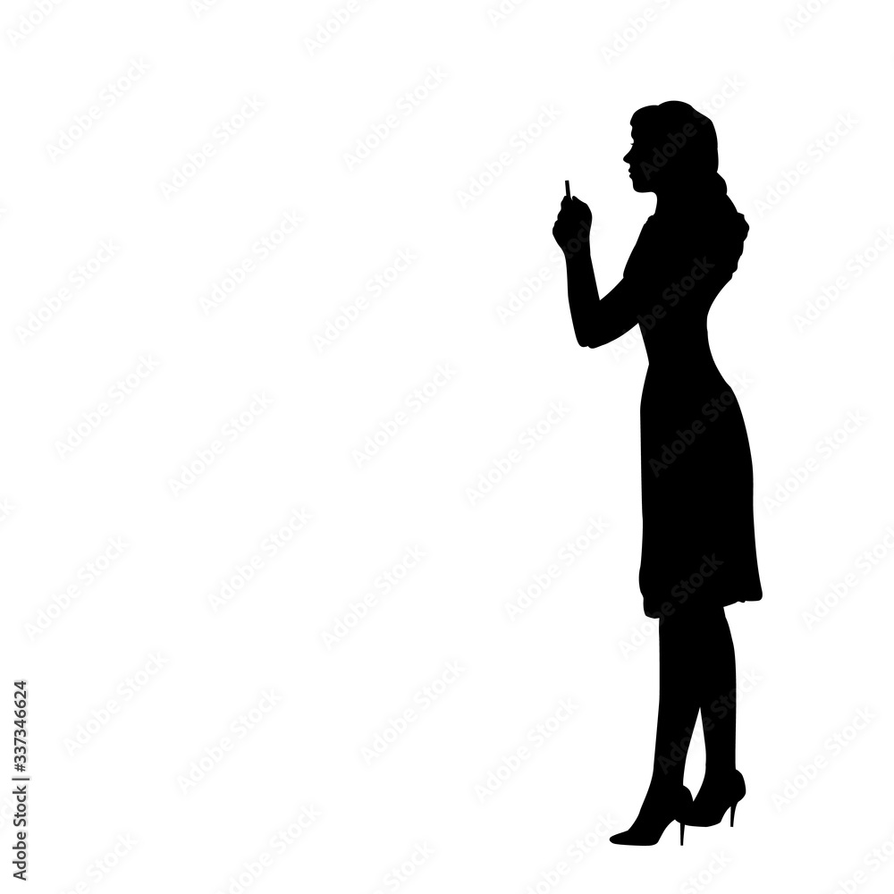 Silhouette woman looks at the phone