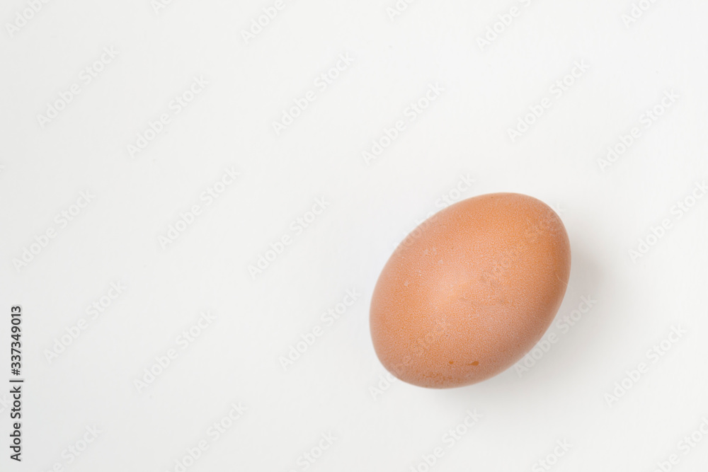 Close up of an egg lying on a white background. There is a place for text. Easter concep.