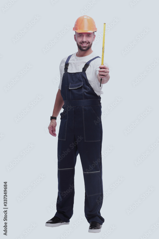 in full growth. man Builder with construction tape measure in full growth. man Builder with construction tape measure