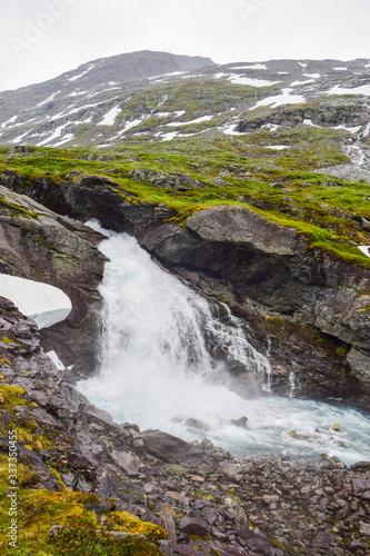 Waterfall and river with clear water. Jostedalsbreen National Park. Norway.