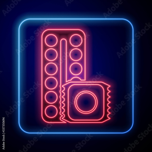 Glowing neon Packaging of birth control pills and condom in package safe sex icon isolated on blue background. Contraceptive pill. Vector Illustration