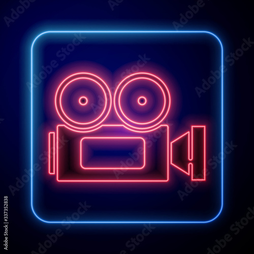 Glowing neon Cinema camera icon isolated on blue background. Video camera. Movie sign. Film projector. Vector Illustration