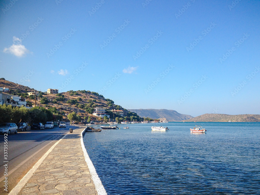 Elounda, Crete, Greece - September 2: path along the sea. Near the road on which cars go.