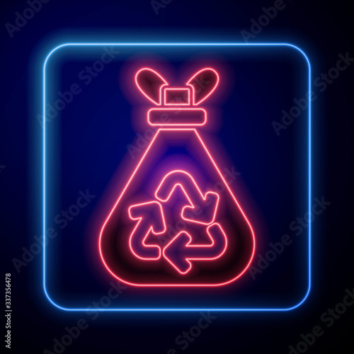 Glowing neon Garbage bag with recycle symbol icon isolated on blue background. Trash can icon. Recycle basket sign. Vector Illustration