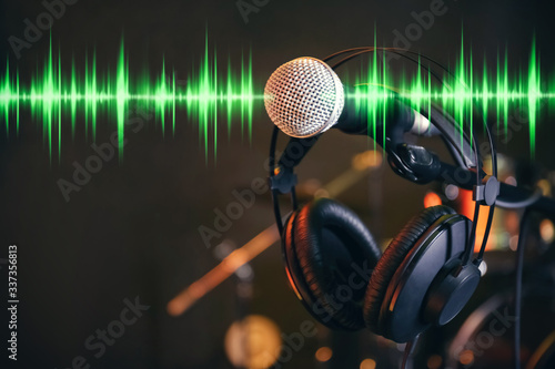 Headphones, microphone and radio wave on dark background © New Africa