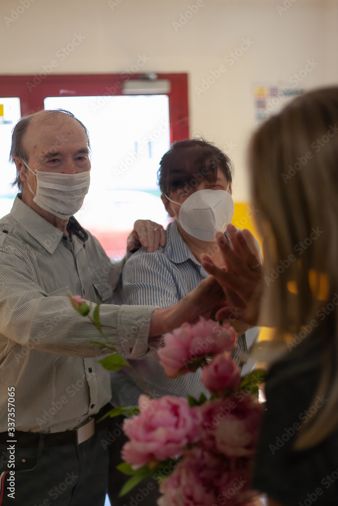 Covid 19. The woman came to visit her old parents who are quarantined.
Communication through glass wall. A period of worldwide influenza pandemic. Looking for better tomorrows.