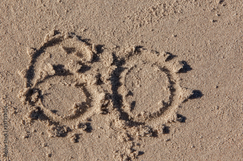 60 written on beach sand