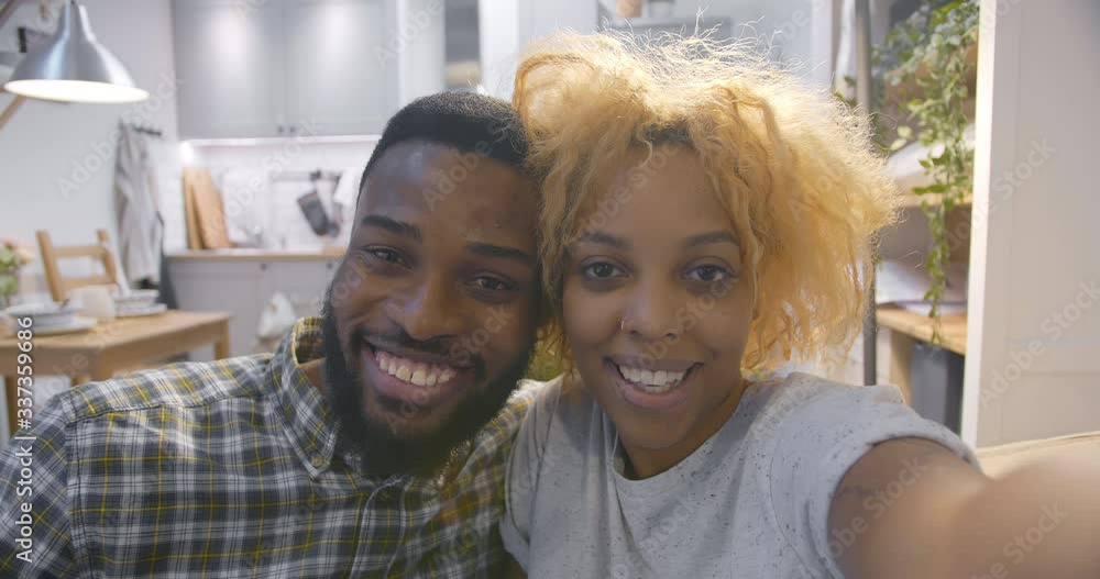 Pov shot of african couple taking selfie in kitchen Pov shot of african couple taking selfie in kitchen