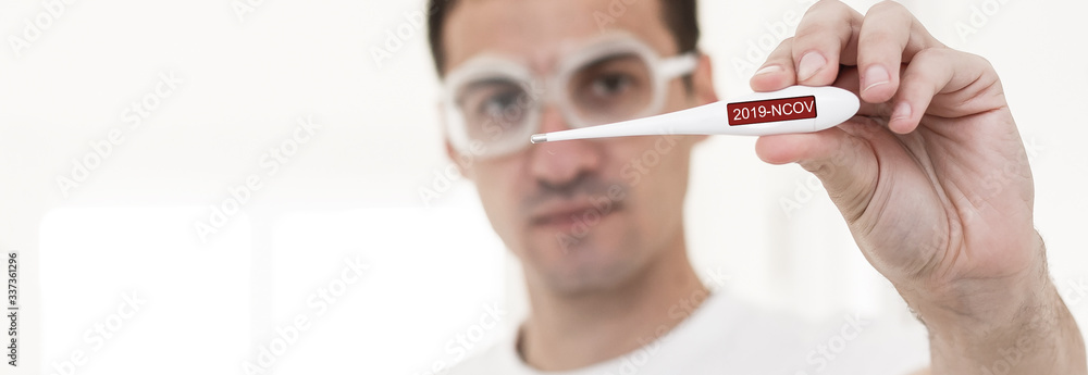people, healthcare and fever concept, man, thermometer over grey background people, healthcare and fever concept, man, thermometer over grey background