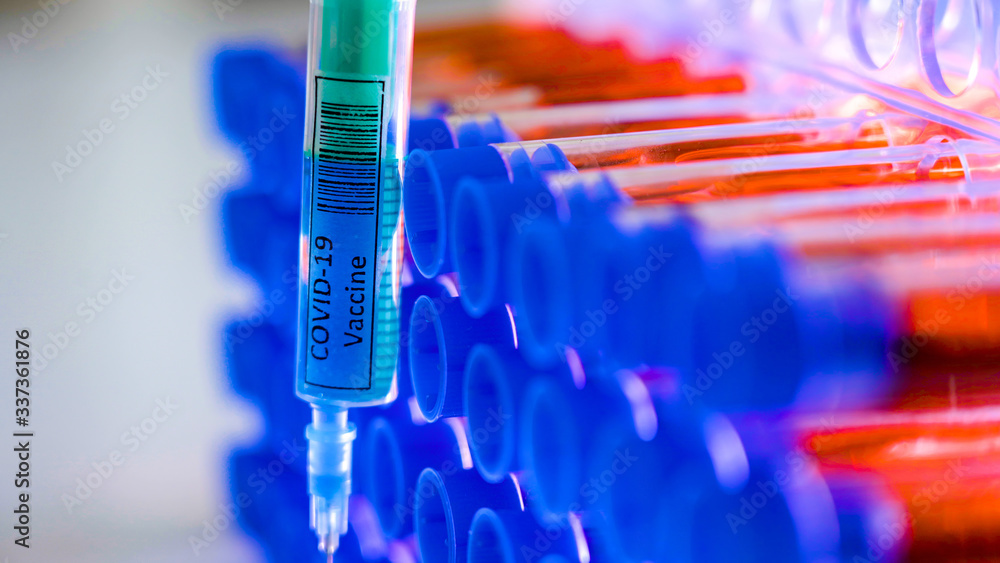 The blue cap of the tubes with the coronavirus syringe The blue cap of the tubes with the coronavirus syringe