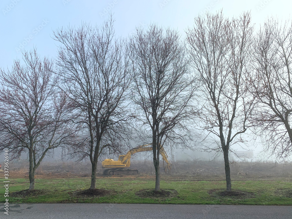 Large Earth Moving Equipment in Field on a Foggy Morning Large Earth Moving Equipment in Field on a Foggy Morning