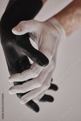 Black and white male hands show gestures and movements. Yin and Yang is the confrontation of black and white good and evil.