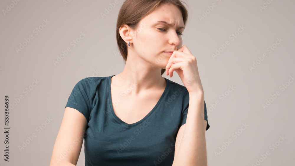 Close up portrait of pretty confident thoughtful girl holding hand near face Close up portrait of pretty confident thoughtful girl holding hand near face