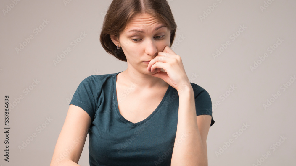 Close up portrait of pretty confident thoughtful girl holding hand near face Close up portrait of pretty confident thoughtful girl holding hand near face