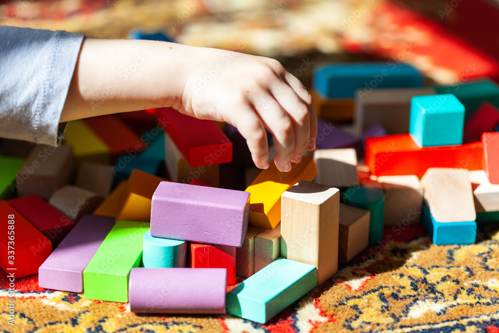 Playing colorful wooden cubes on carpet, sun Playing colorful wooden cubes on carpet, sun