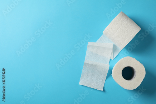Toilet paper on blue background, space for text