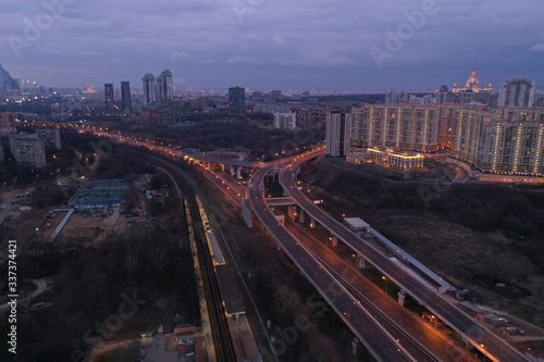 the lights of the big city and the motorway at night shot from the drone