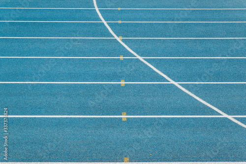 Blue Running track .Lanes of blue running track.Running track with blue asphalt and white markings in outdoor stadium