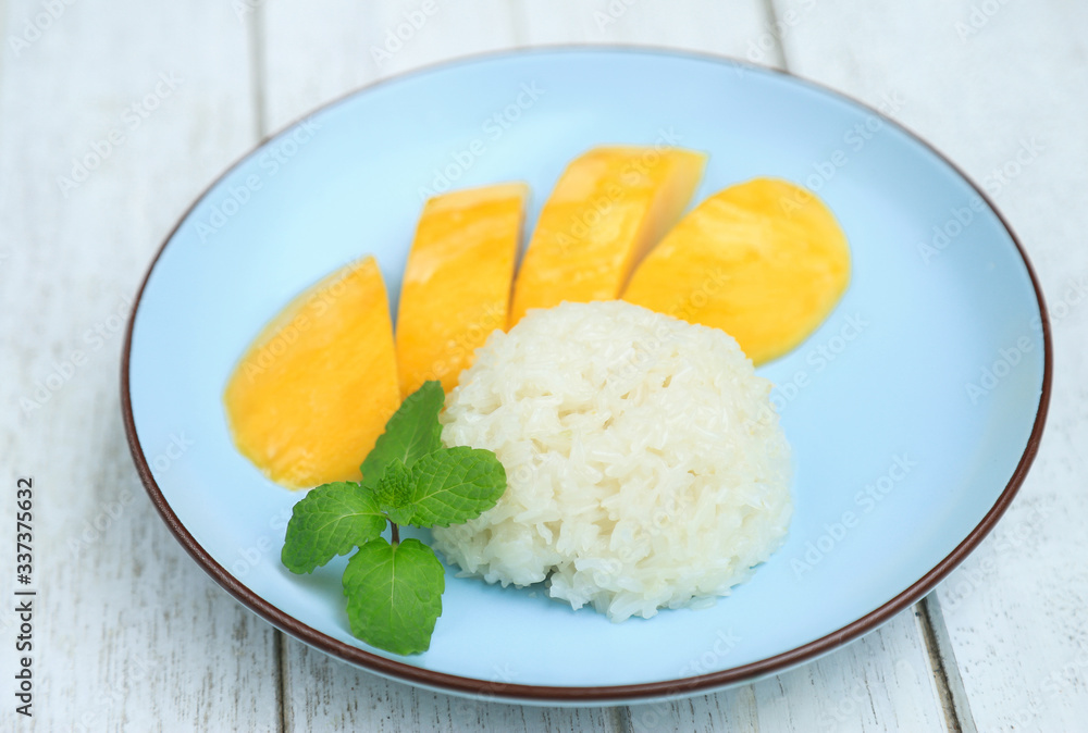 Sweet mixed coconut milk with sticky rice and yellow mango fruit on dish serving. Thai dessert for eating in daily life Sweet mixed coconut milk with sticky rice and yellow mango fruit on dish serving. Thai dessert for eating in daily life