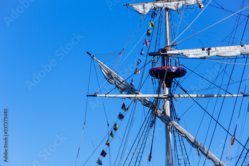 Mast yacht without sails against the blue sky 