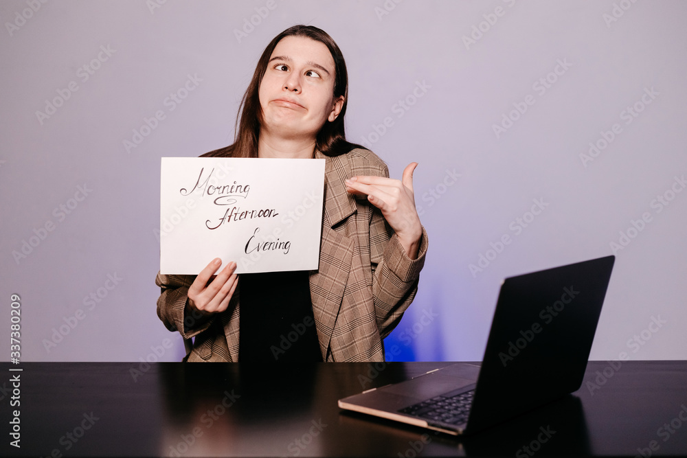 The girl teaching English and shows phrases using signs at. Innovative pedagogy to teaching in online school.A new english course is available online. The girl teaching English and shows phrases using signs at. Innovative pedagogy to teaching in online school.A new english course is available online.