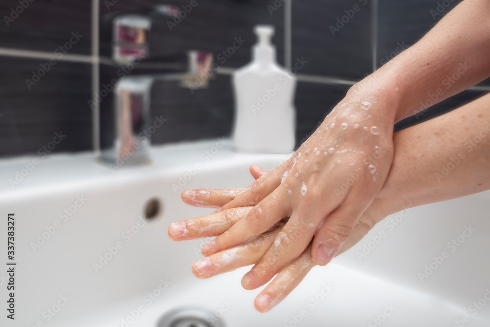 Woman washing hands with soap. An unrecognizable female showing how to wash hands properly. Coronavirus or COVID-19 prevention Woman washing hands with soap. An unrecognizable female showing how to wash hands properly. Coronavirus or COVID-19 prevention