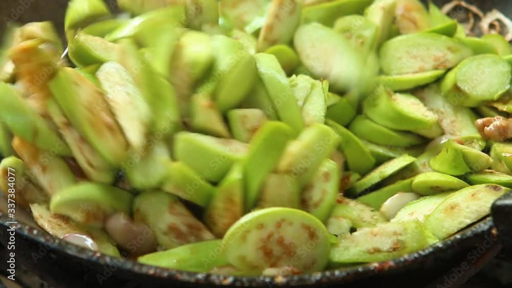 Frying eggplant with minced pork in pan , in door Chiangmai Thailand Frying eggplant with minced pork in pan , in door Chiangmai Thailand