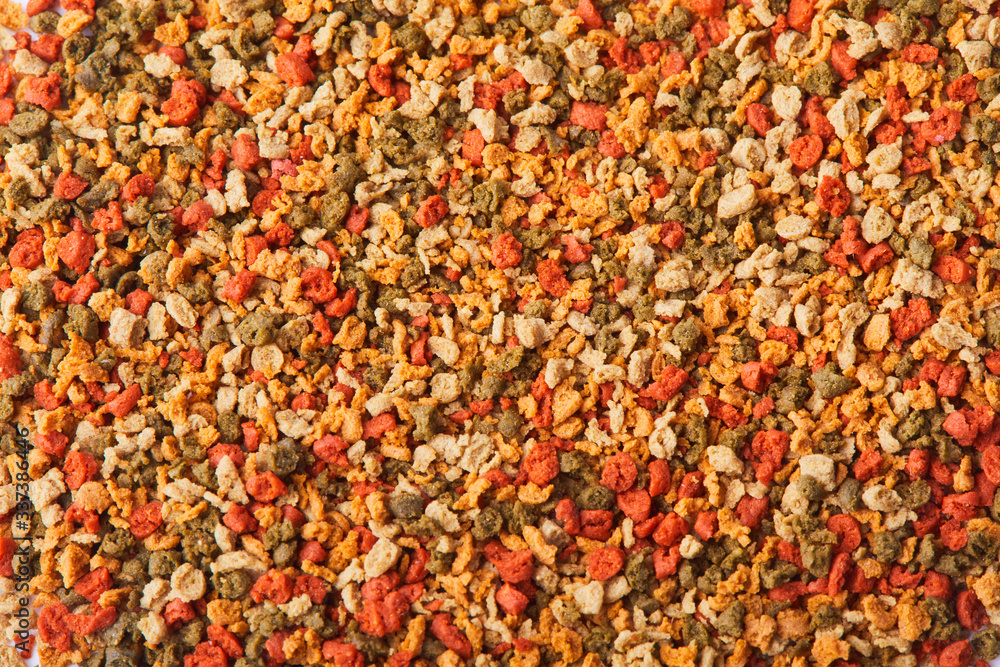 Dry colorful compound fish feed granules background. Top view Dry colorful compound fish feed granules background. Top view