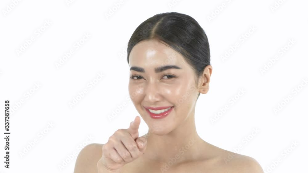 Beauty concept. A beautiful woman pointing her finger on a white background. 4k Resolution.