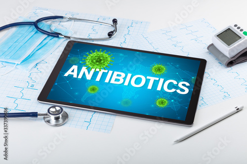Close-up view of a tablet pc with ANTIBIOTICS inscription, microbiology concept