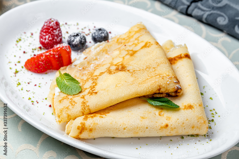 Pancakes with berries on white plate Pancakes with berries on white plate
