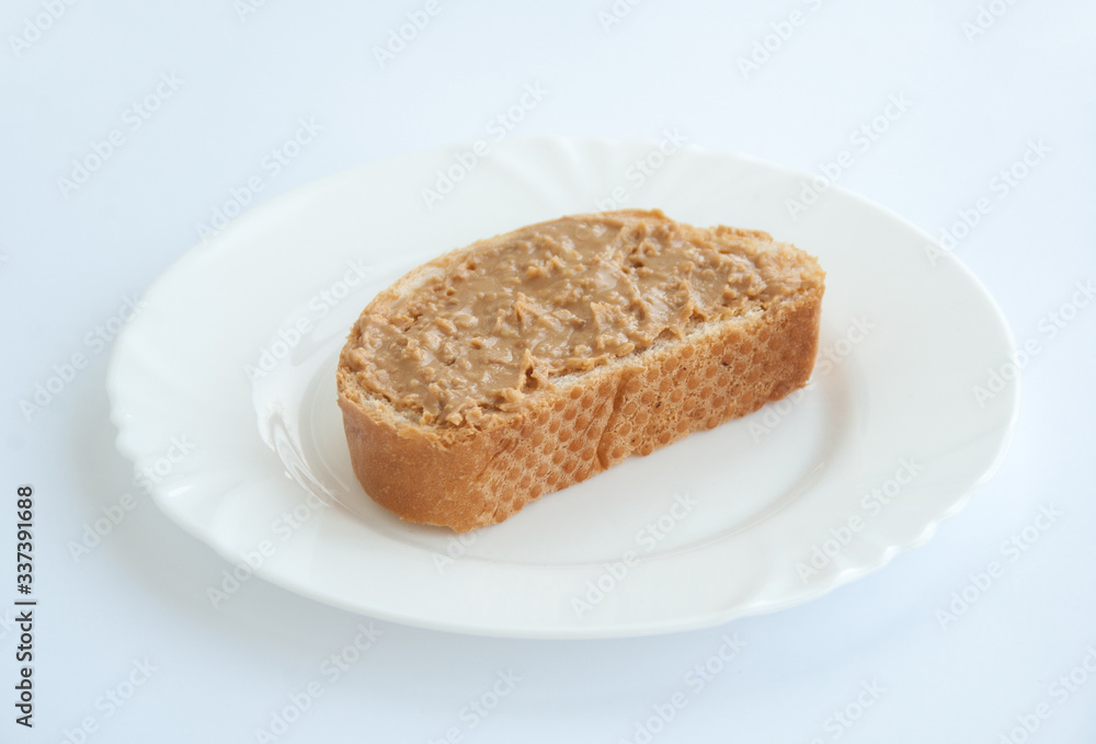 peanut butter toast on a white plate isolated on white background peanut butter toast on a white plate isolated on white background