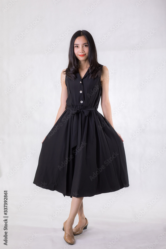 Beautiful Asian woman wear black dress. Standing in front of a white background. Beautiful Asian woman wear black dress. Standing in front of a white background.