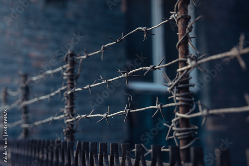 barbed wire stretched in 3 layers on the fence