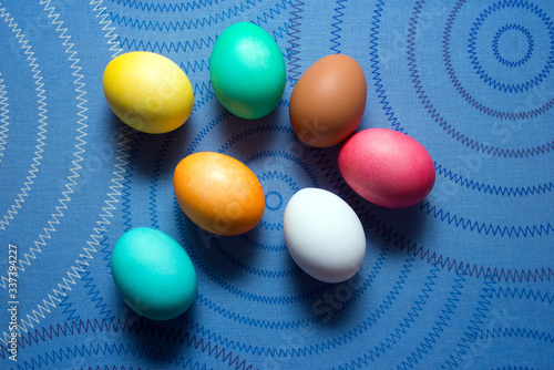 Colored easter eggs on a blue background with a pattern