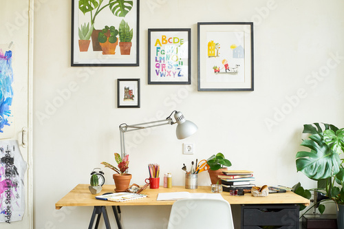 Artist's workplace for working from home with watercolor paints, brushes and sketchbooks. Place for design, illustration and creativity.