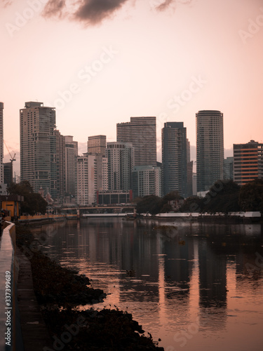 Skyline of Makati City reflecting in the Pasig River in Metro Manila, Philippines while sunrise © SmallWorldProduction