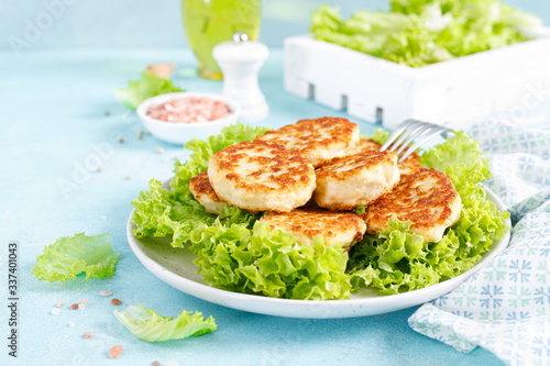 Chicken cutlets with fresh lettuce salad on plate