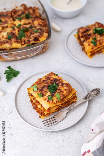 Delicious homemade italian Lasagna with bachamel sauce on gray background. Hot tasty Lasagna with cheese photo