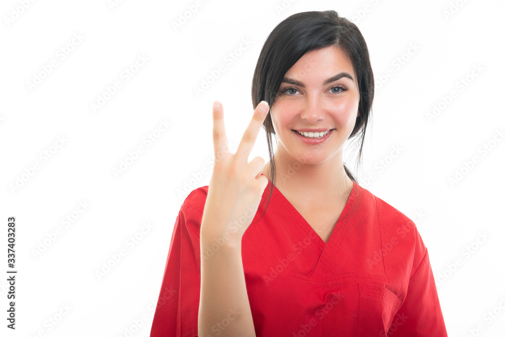 Portrait of young attractive female nurse showing number two Portrait of young attractive female nurse showing number two