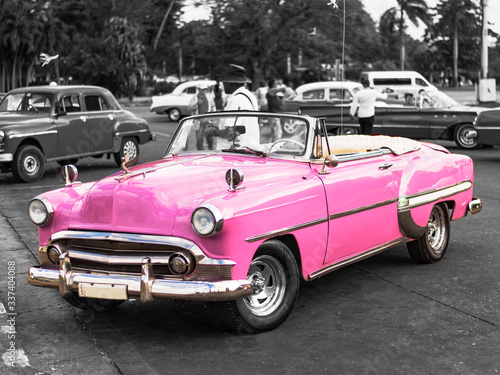 Photography colorkey of vintage pink convertible car on the street of havana cuba