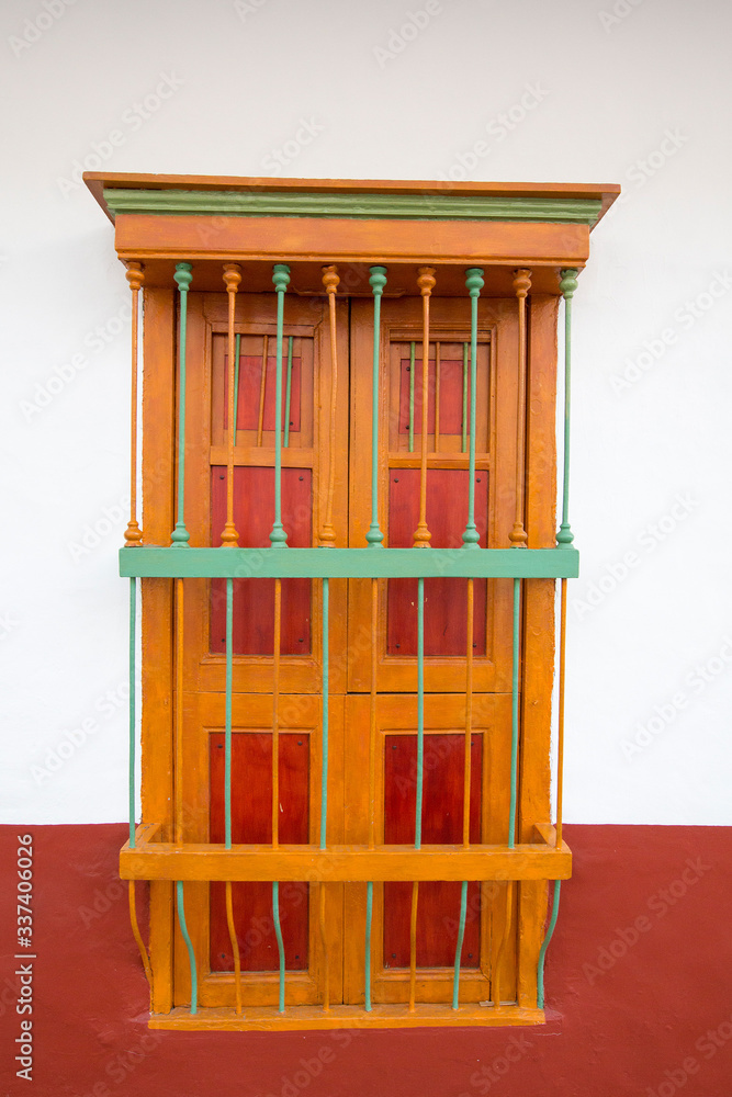 Bright yellow wall and window details, colonial architecture in Cali. Colombia Bright yellow wall and window details, colonial architecture in Cali. Colombia